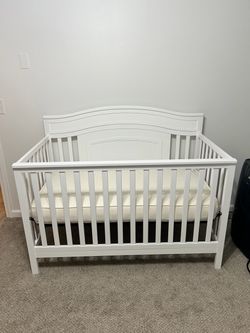 White crib and mattress