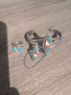 vintage Navajo slave bracelet featuring sterling silver, turquoise, and coral stones