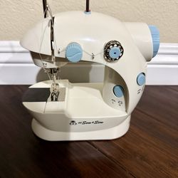 Mini Sewing Machine. Includes Foot Pedal, Power Adapter, 2 Bobbins, Operation Manual
