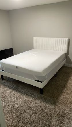 White upholstery queen sized bed frame