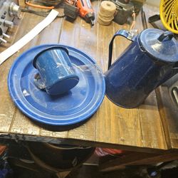 blue enamel coffee pot with a matching cup and plate