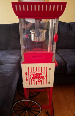 Nostalgia brand popcorn popper with cart.