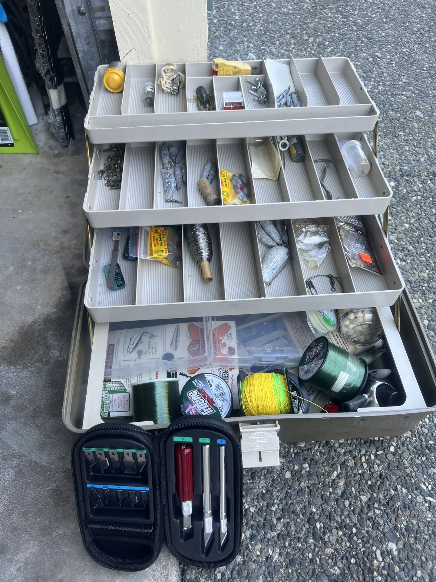 multi-tiered tackle box filled with various fishing gear and accessories