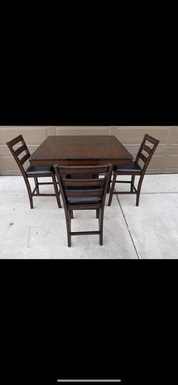 Dining table with three chairs in good condition