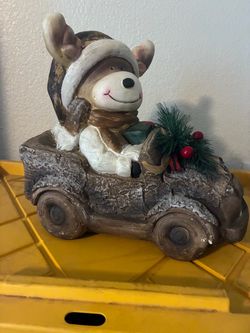 Christmas reindeer in vintage truck with lights