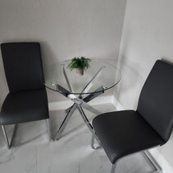 Modern Round Tempered Glass Dining Table and Grey faux leather with Chrome finish Chairs