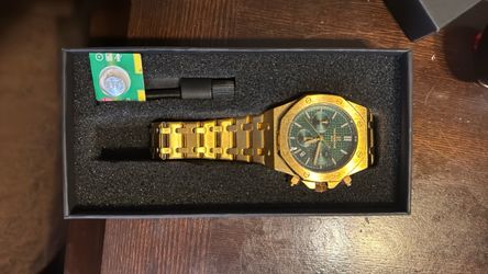 Gold watch with green dial