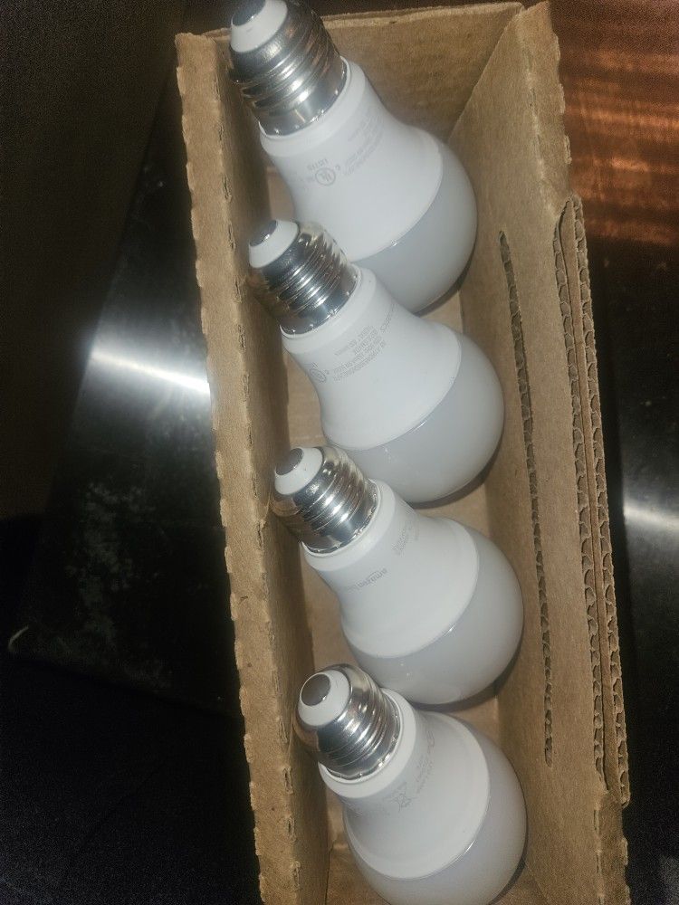 4 Pack Amazon Basics light bulbs. LED 120V 69Hz 809 lumens