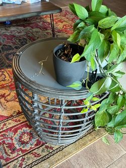 Gray wicker accent table with glass top
