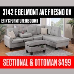 GRAY SECTIONAL WITH STORAGE OTTOMAN AND CUP HOLDERS