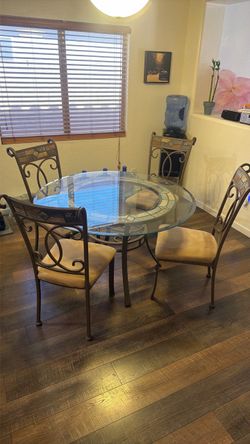 Cast iron dining room table glass top with four chair chairs
