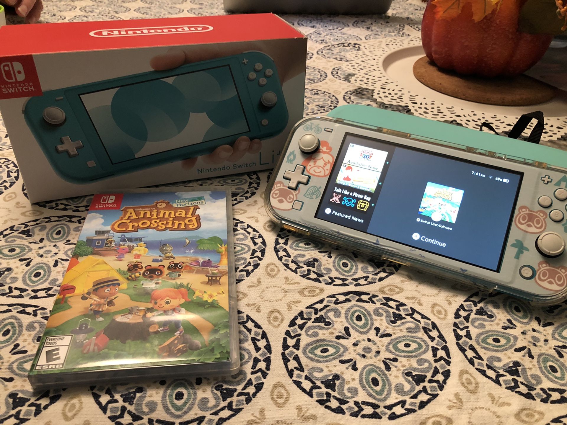 Nintendo Switch Lite in teal + Animal Crossing New Horizons