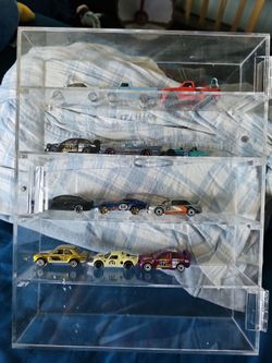 Clear display case with 12 cars.