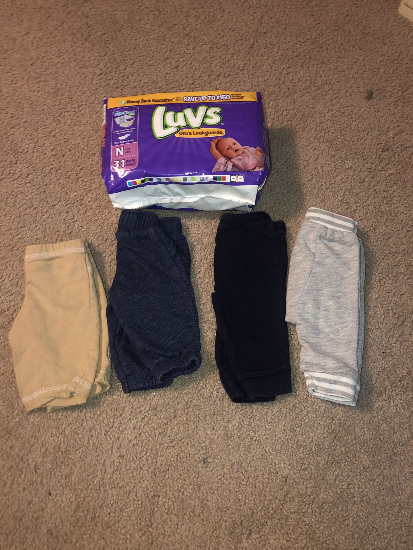31 newborn diapers & 4 pairs of newborn pants