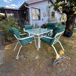 Glass top table and four matching chairs