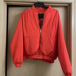 New with tags adorable orange women’s size small short bomber type jacket.   