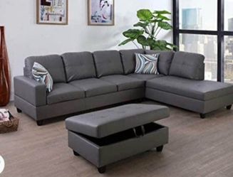 Gray leather sectional couch and ottoman