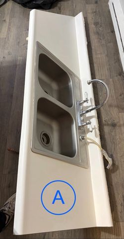 White countertop w/ waterfall edge, integrated backsplash & full sink