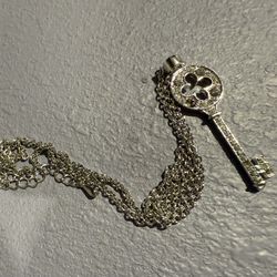 A Stylish Sterling Silver Necklace Adorned With A Sparkling Cz Key Pendant, Perfect For Adding A Touch Of Charm And Elegance To Any Outfit