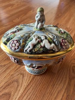 Vintage, hand-painted Capodimonte covered tureen featuring cherubs and floral motifs in relief.