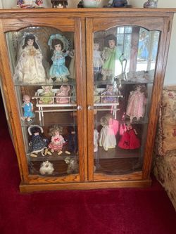Display case with handmade dolls