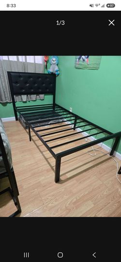 Metal frame with a twin-size mattress