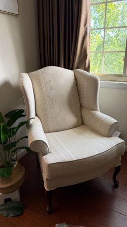 Beige wing back chair