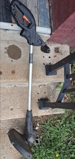 Corded weedwacker. Metal gas can. Wall picture