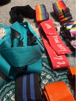 A Colorful Collection of Luggages’ Straps for Holding and Marking the Suitcases