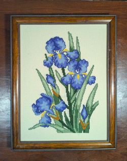 Framed cross stitch wall art piece of blue irises