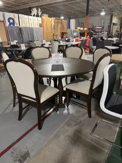 Brand new 60” round dining table with 6 chairs. Brown