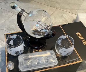 Whiskey decanter set with glasses. Globe with Ship in a bottle.