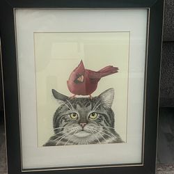 Framed print by artist Tracy Lizotte featuring a cat and a cardinal. 16”x 12.75” Including Frame 