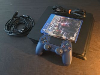Sony PS4 Playstation 4 Slim 1TB Mattle Black Gaming Console w/DualShock 4 wireless controller, an HDMI cable, a power cord, and a USB charging cable
