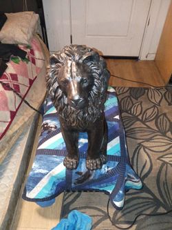 It is a heavy plastered plastic lion black and iron mix colors