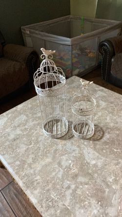 Metal containers you could put candles in there flowers that have the birds on top