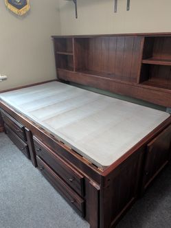 Twin bed with under bed drawers and storage.        Also, 5 drawer dresser.