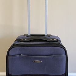 Dumont black-and-blue fabric carry-on rolling suitcase with retractable handle.
