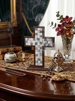 A natural stone mosaic cross depicting the birth of Jesus.