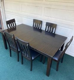 LIKE NEW 7-PC ASHLEY HADDIGAN FORMAL DINING SET BROWN FINISHED (TABLE WITH LEAF AND 6 PADDED CHAIRS)