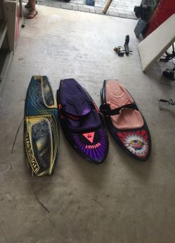 2 knee boards and a wakeboard