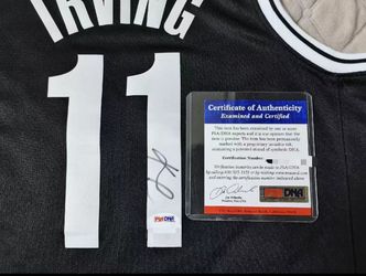 21-22 PSA Kyrie Irving signs the jersey