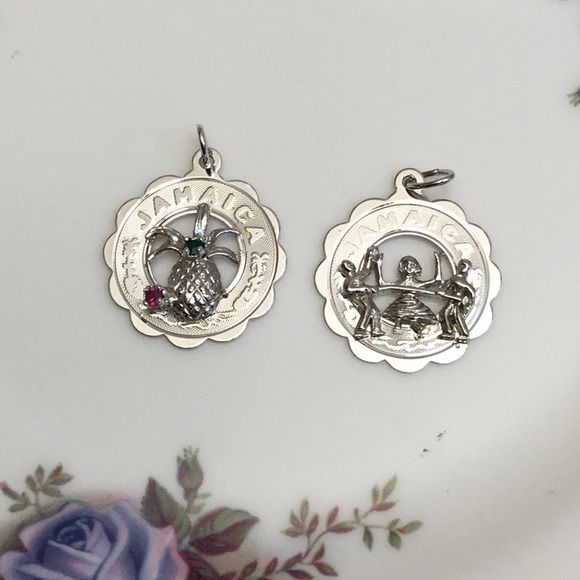 2 Jamaica silver charms