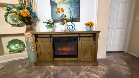 Beautiful rustic fireplace/tv stand in excellent condition with barn doors