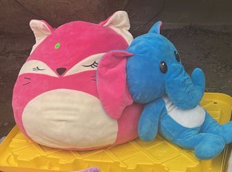 Big pink squishy pillow and a blue elephant stuffed animal