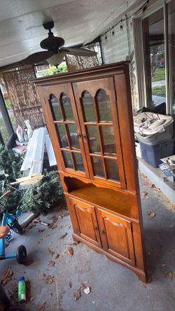 Traditional wooden china cabinet / china hutch with glass display doors and lower storage cabinets.