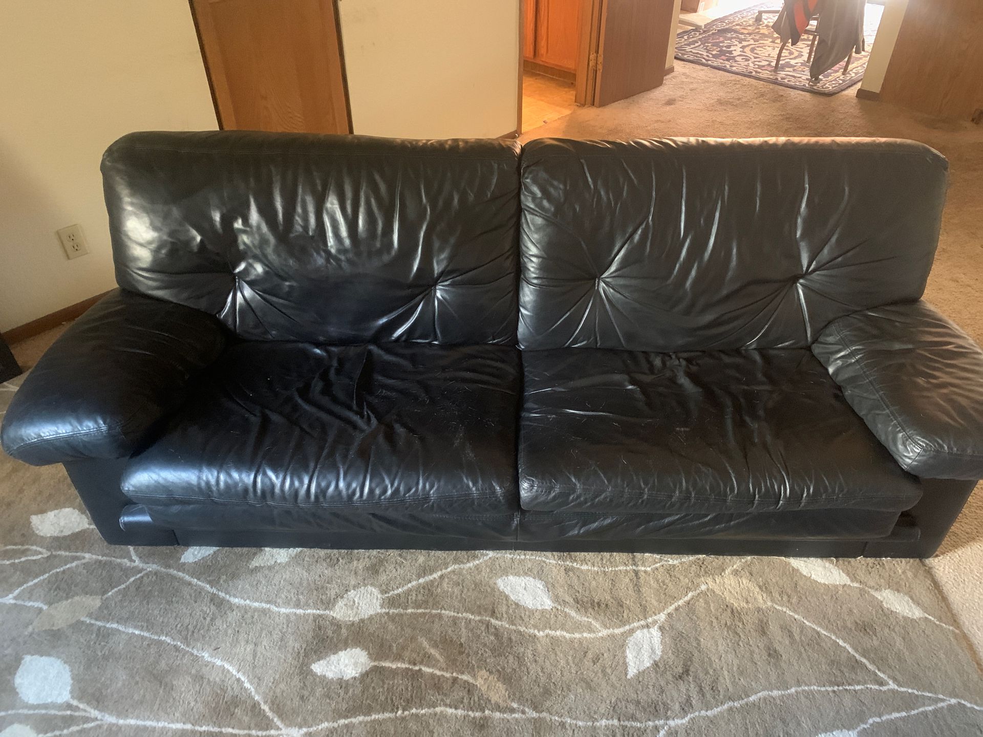 Selling black leather sofa