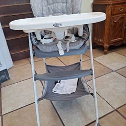 High Chair And Baby Roller toy . Only used Once.