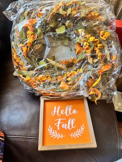 Seasonal autumn 22” wreath featuring orange flowers and green foliage.