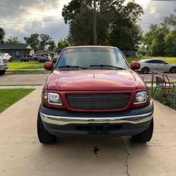 Red 2001 Ford F150 XLT Supercab shortbed with 2 wheel drive, V6 